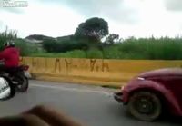 Biker towing a car on highway 