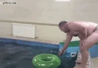 Fat guy jumps through swim ring